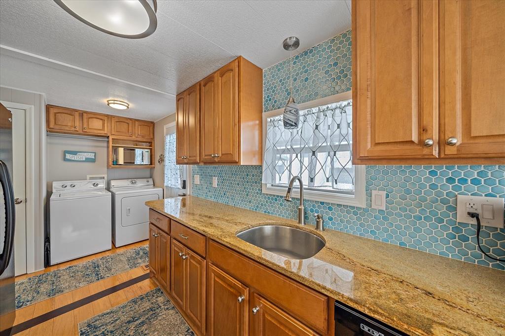 521 Roma Road Venice, FL 34285 - Photo 12 of 57 a kitchen with stainless steel appliances granite countertop a sink stove and refrigerator