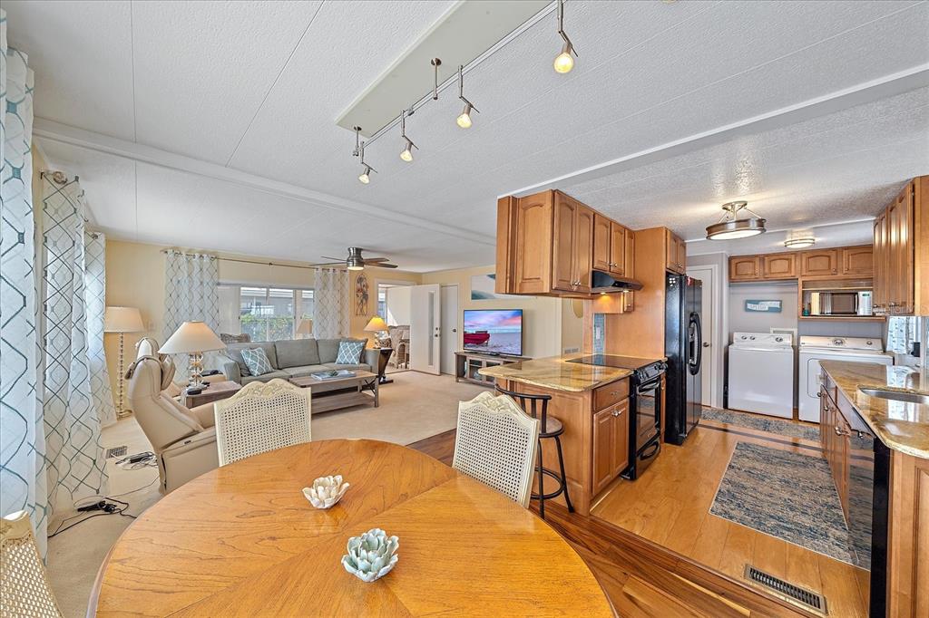 521 Roma Road Venice, FL 34285 - Photo 15 of 57 a living room with stainless steel appliances furniture stove and kitchen view
