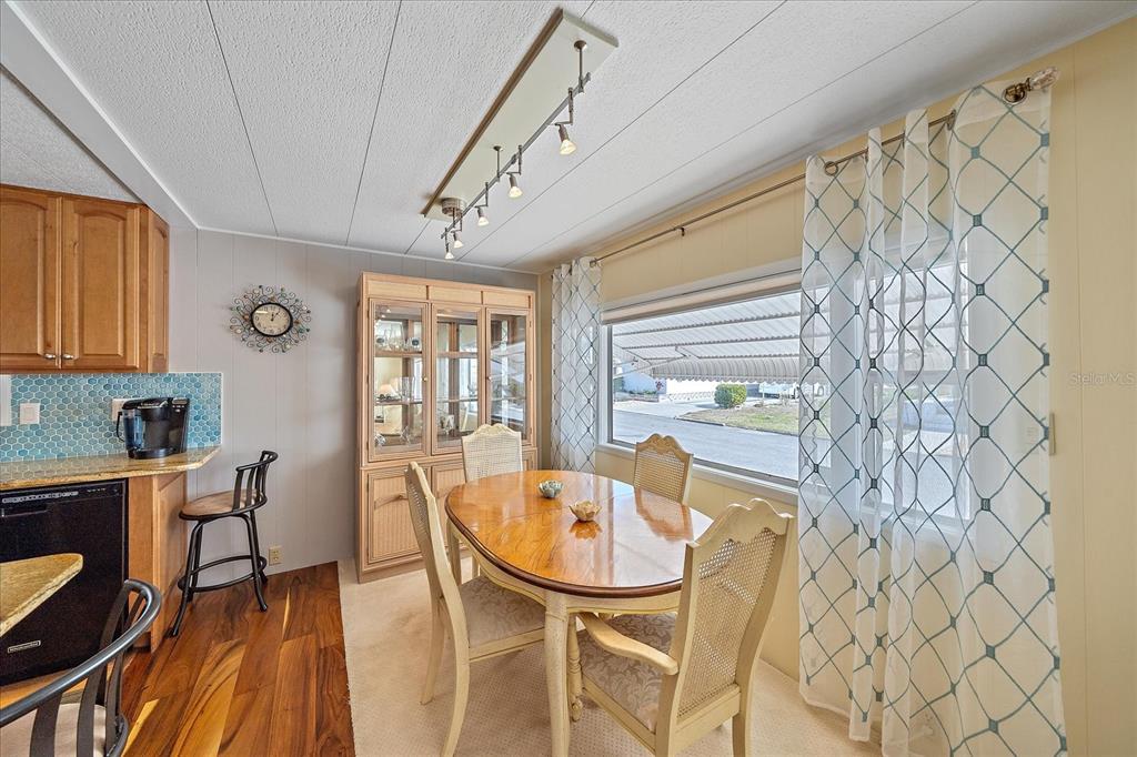 521 Roma Road Venice, FL 34285 - Photo 16 of 57 a dining room with furniture and wooden floor