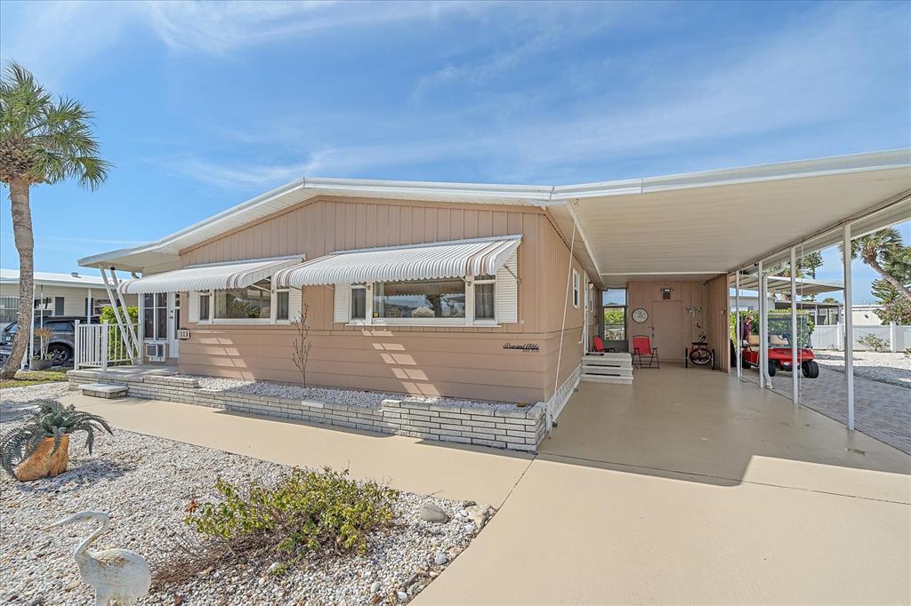 521 Roma Road Venice, FL 34285 - Photo 2 of 57 a front view of a house with a patio