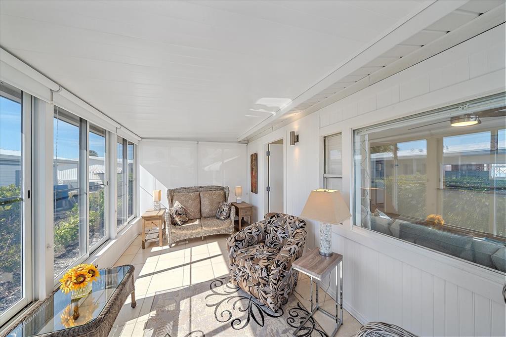521 Roma Road Venice, FL 34285 - Photo 21 of 57 a living room with furniture and floor to ceiling windows