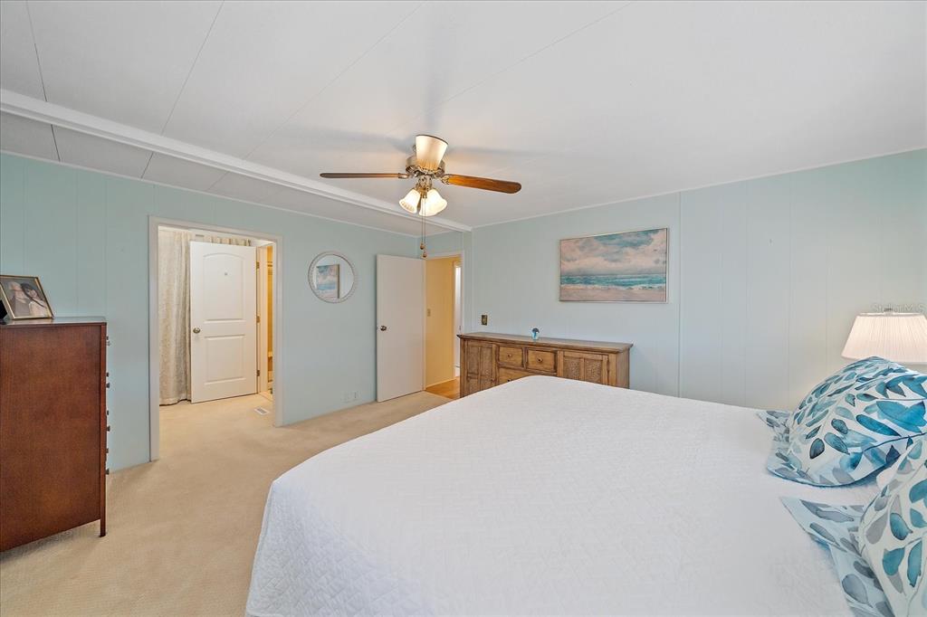521 Roma Road Venice, FL 34285 - Photo 24 of 57 a bedroom with a bed and a chandelier