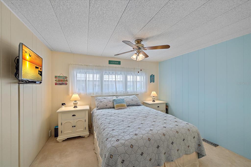521 Roma Road Venice, FL 34285 - Photo 26 of 57 a bedroom with a bed and a chandelier