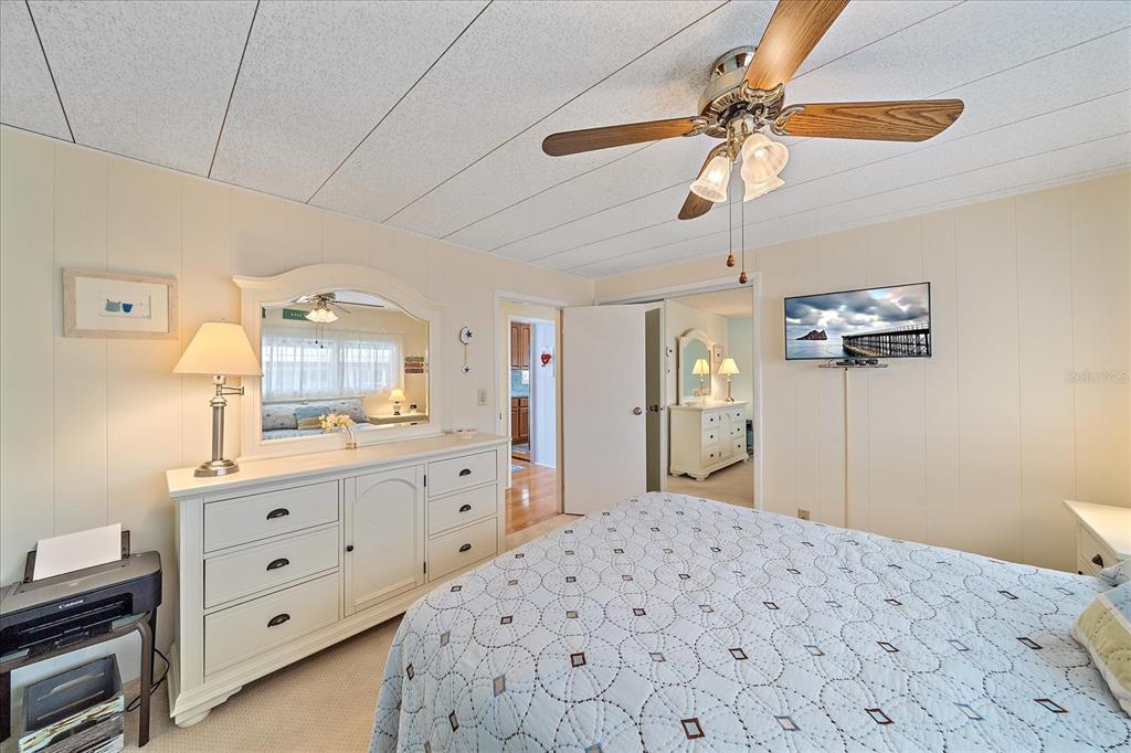 521 Roma Road Venice, FL 34285 - Photo 27 of 57 a bedroom with a bed a chandelier and dresser