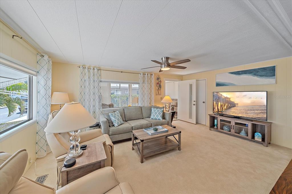 521 Roma Road Venice, FL 34285 - Photo 4 of 57 a living room with furniture and a flat screen tv