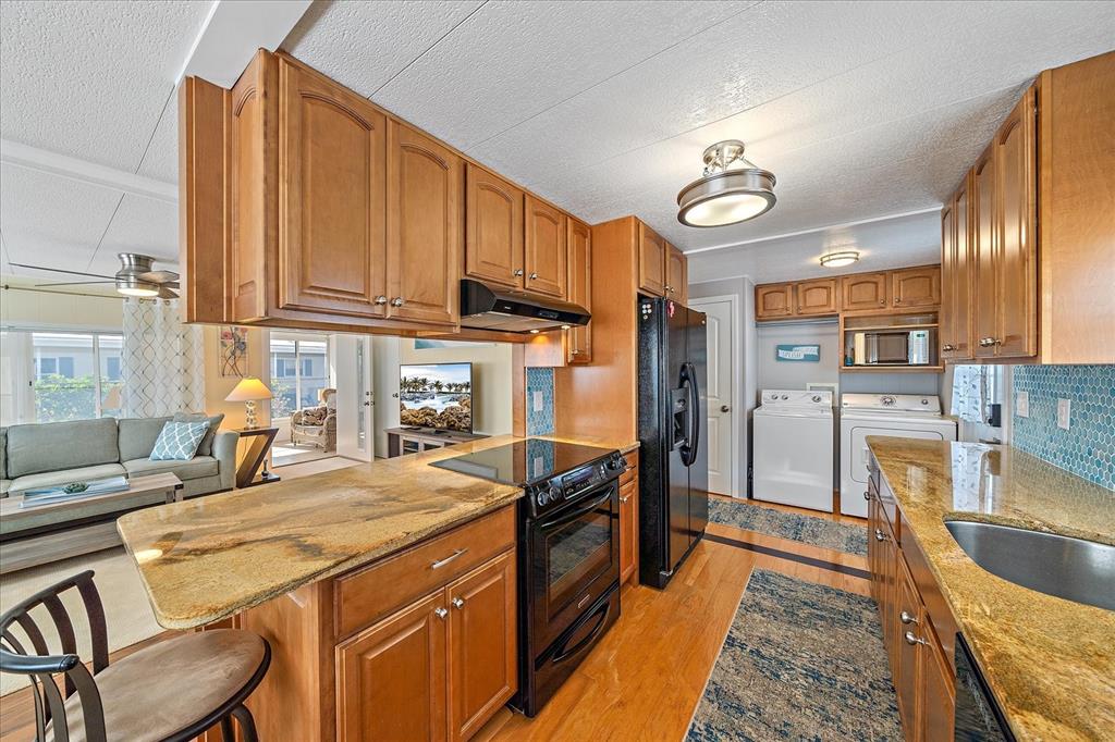 521 Roma Road Venice, FL 34285 - Photo 9 of 57 a kitchen with stainless steel appliances granite countertop a sink a stove and refrigerator
