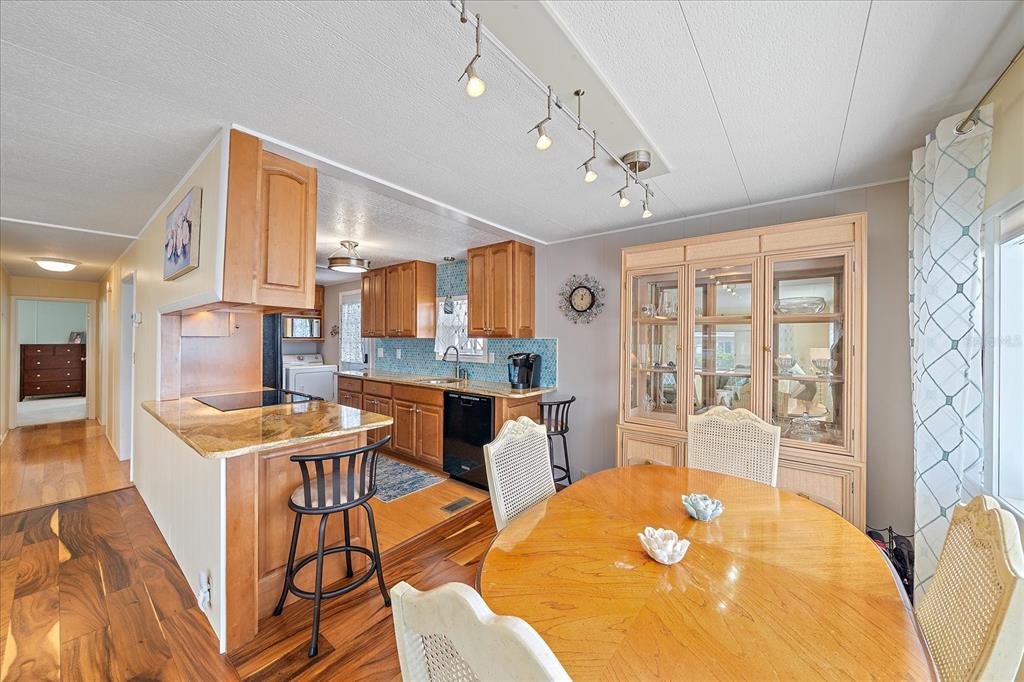 521 Roma Road Venice, FL 34285 - Photo 10 of 57 a view of a dining room with furniture and a large window