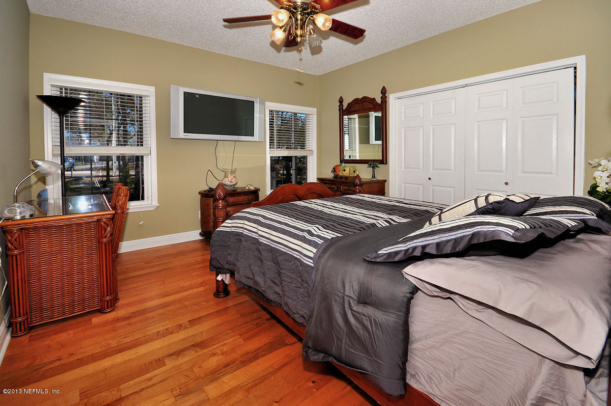 16024 Shellcracker Road Jacksonville, FL 32226 - Photo 16 of 26 a bedroom with a bed and a flat screen tv