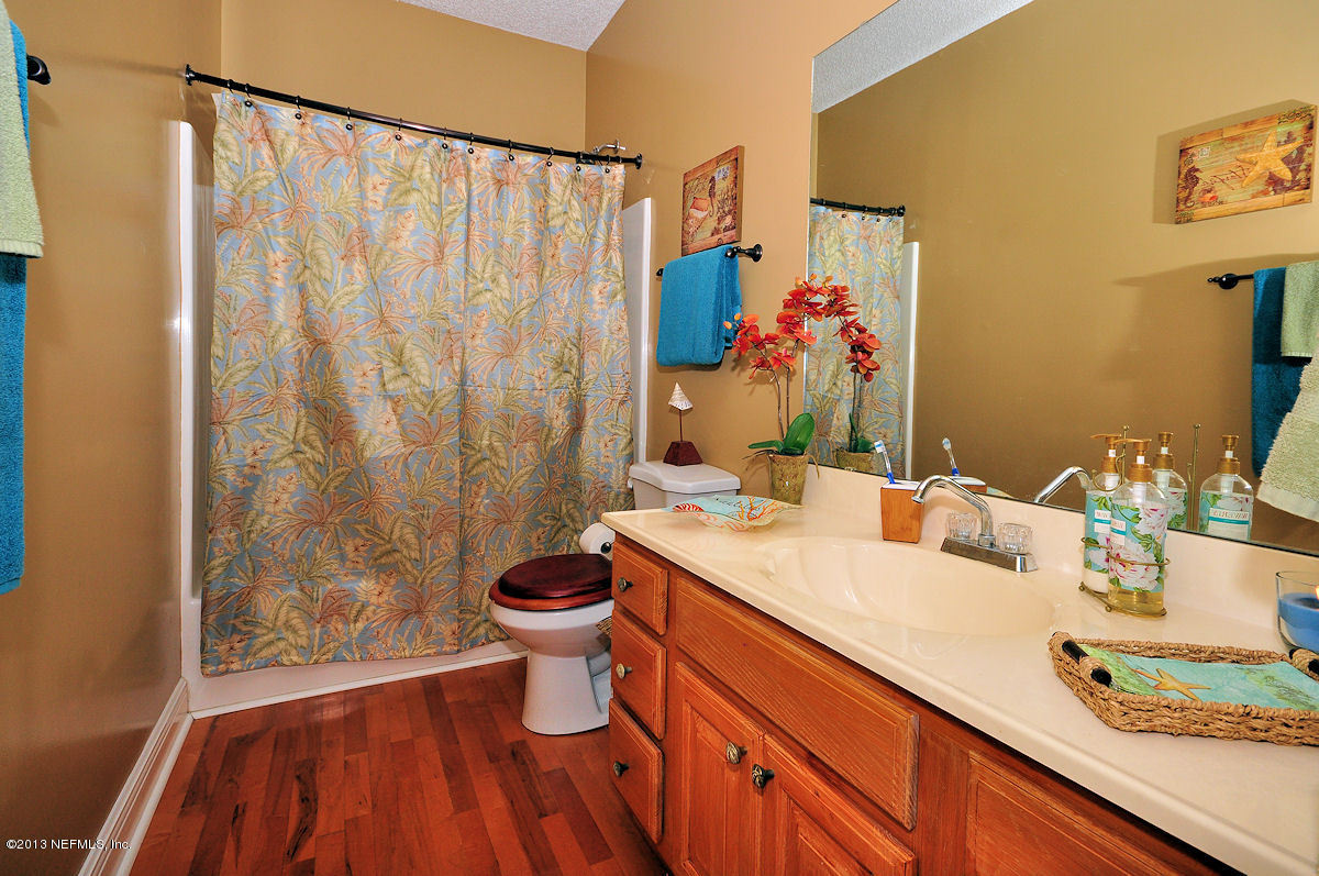 16024 Shellcracker Road Jacksonville, FL 32226 - Photo 17 of 26 a bathroom with a granite countertop sink and a mirror