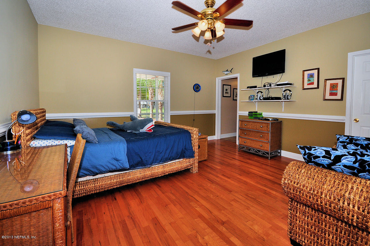 16024 Shellcracker Road Jacksonville, FL 32226 - Photo 18 of 26 a bedroom with furniture and a flat screen tv
