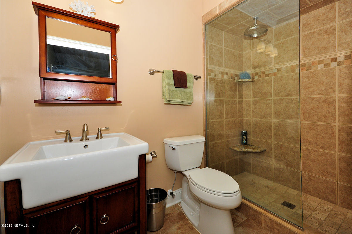 16024 Shellcracker Road Jacksonville, FL 32226 - Photo 19 of 26 a bathroom with a sink mirror and toilet