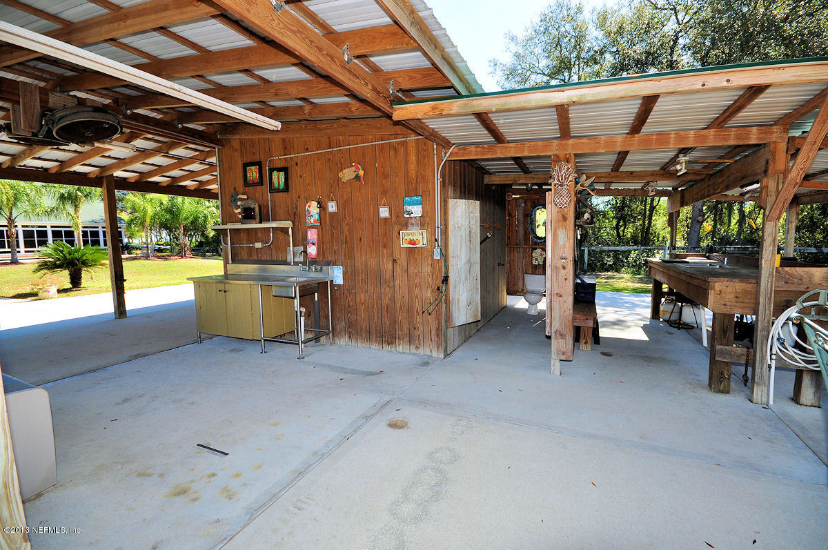 16024 Shellcracker Road Jacksonville, FL 32226 - Photo 24 of 26 a view of a storage room with a table and chairs