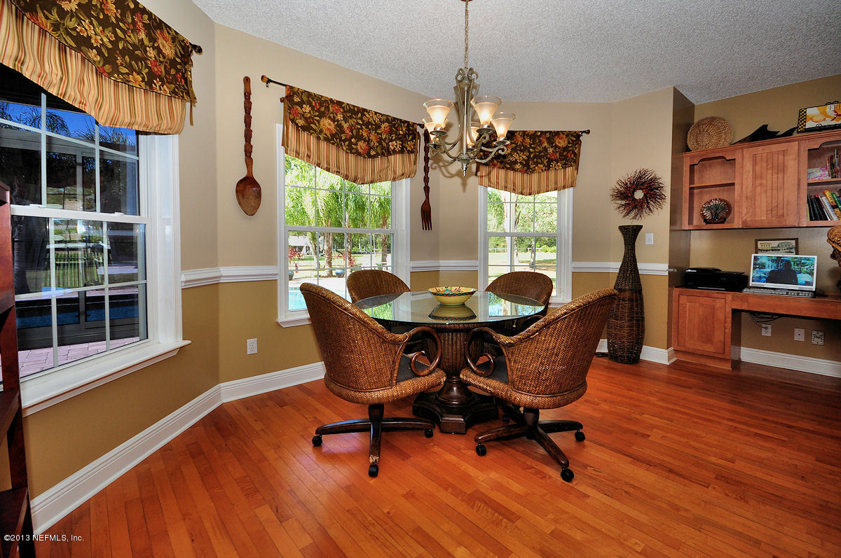 16024 Shellcracker Road Jacksonville, FL 32226 - Photo 6 of 26 a dining room with furniture a chandelier and wooden floor