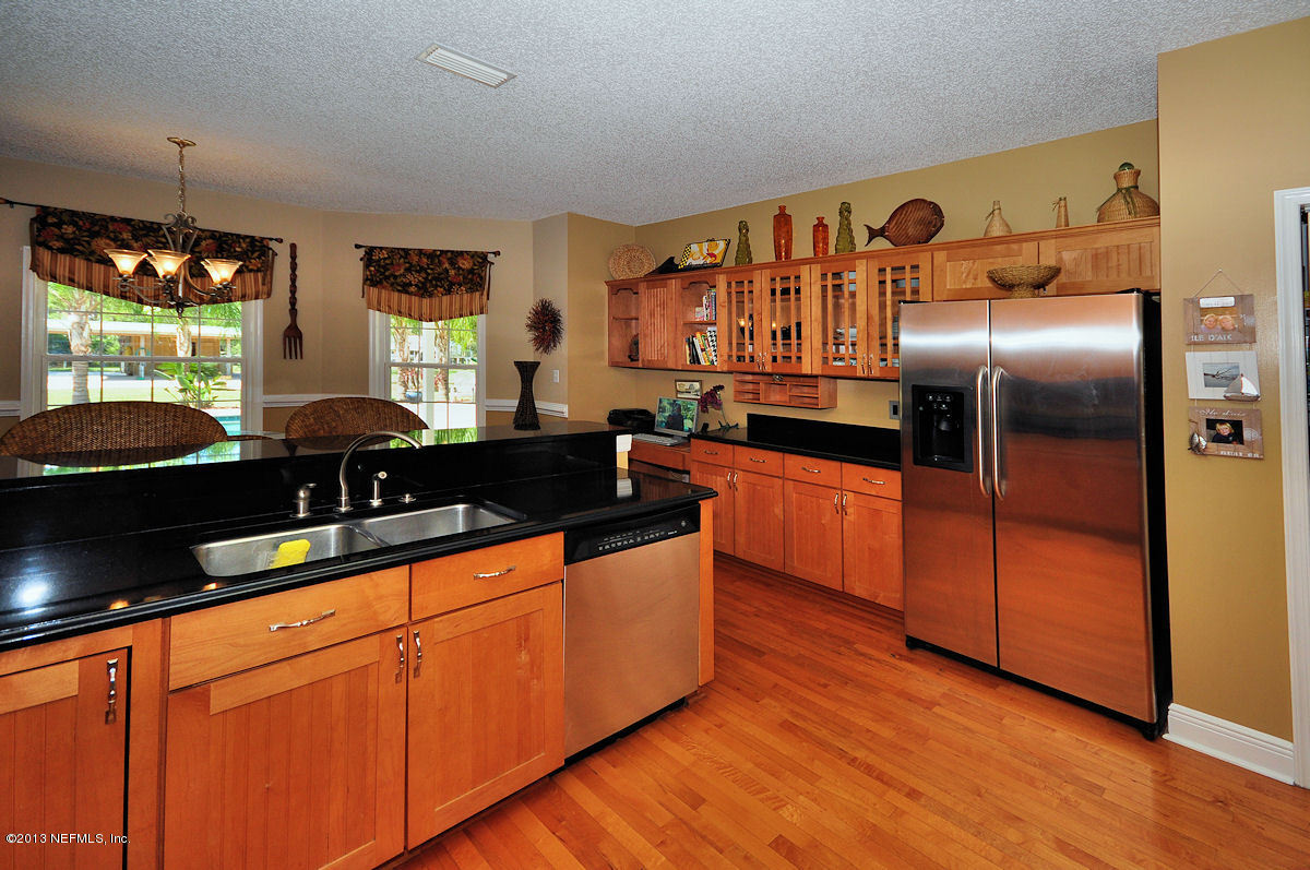 16024 Shellcracker Road Jacksonville, FL 32226 - Photo 8 of 26 a kitchen with stainless steel appliances granite countertop a sink and a refrigerator