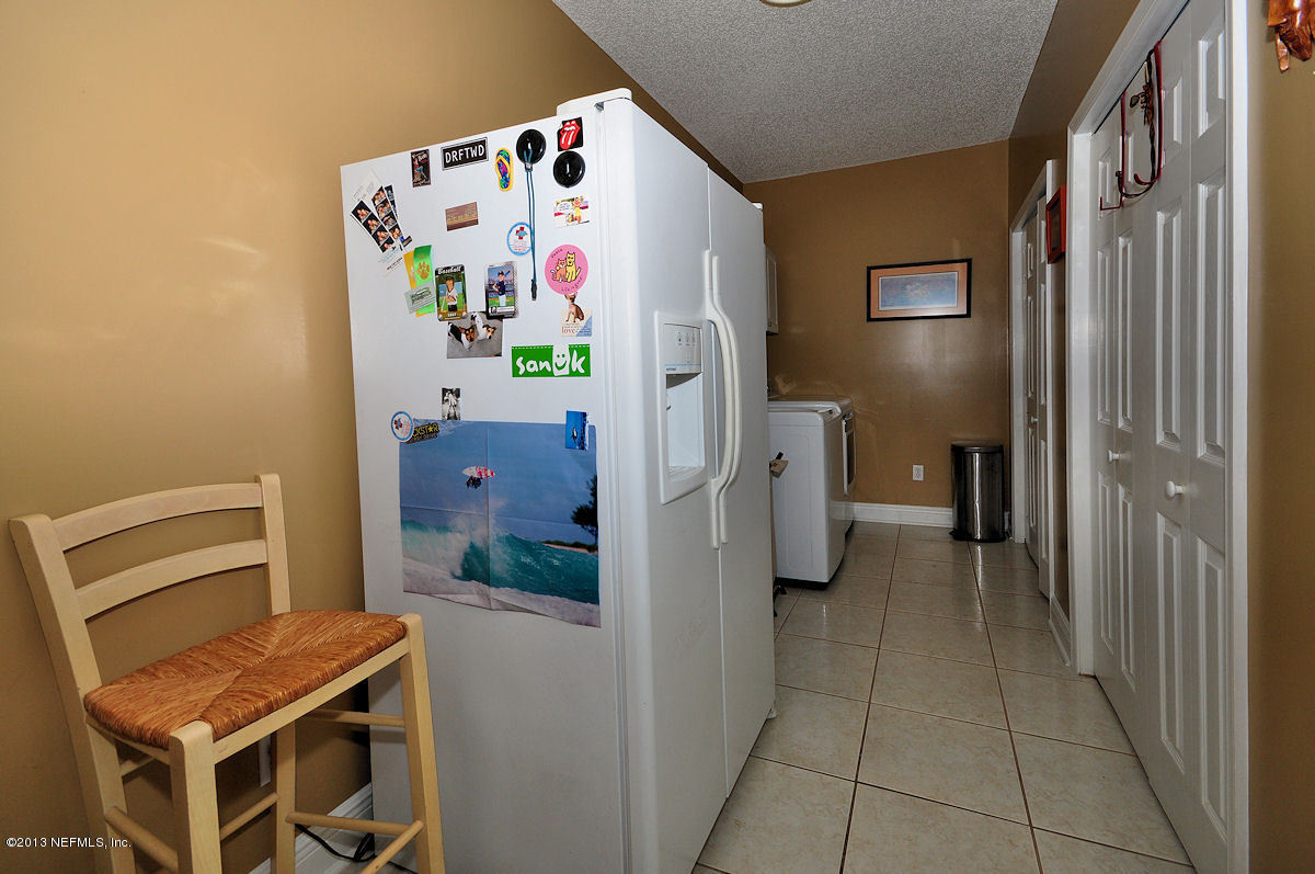 16024 Shellcracker Road Jacksonville, FL 32226 - Photo 9 of 26 a kitchen with a refrigerator and dishwasher