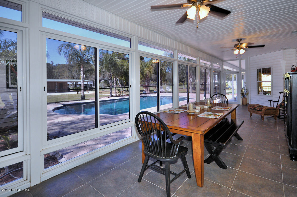 16024 Shellcracker Road Jacksonville, FL 32226 - Photo 10 of 26 a dining room with furniture and a floor to ceiling window