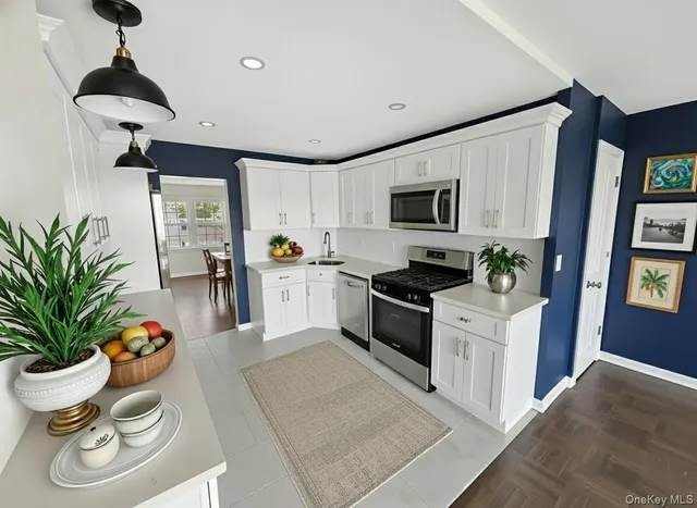 a kitchen with stainless steel appliances granite countertop a sink stove and cabinets