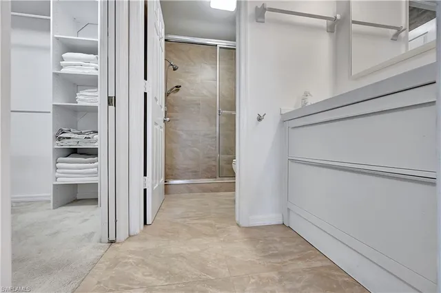 a view of walk in closet with empty racks