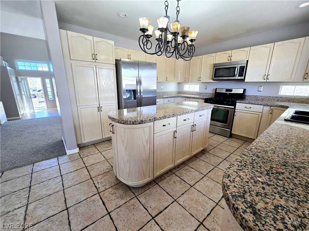 3759 Funston Way Las Vegas, NV 89129 - Photo 21 of 31 A gourmet kitchen offers granite countertops, an island, and sleek stainless steel appliances.