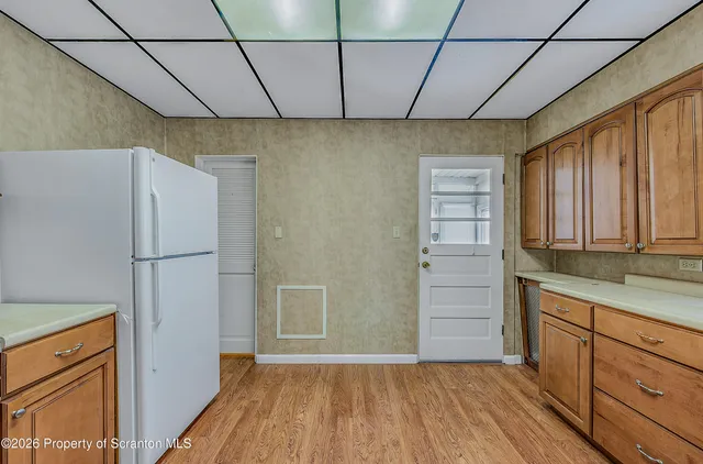 a view of a patio with table and chairs with wooden floor and fence