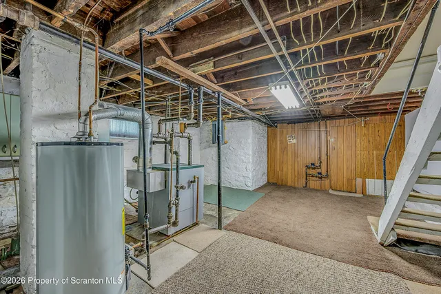 an empty room with a window and a ceiling fan