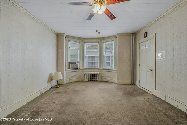 a view of a room with a chandelier and large window