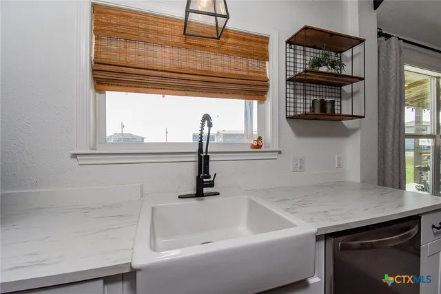 a kitchen with a sink and a window