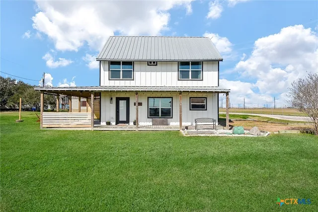a front view of a house with swimming pool having outdoor seating