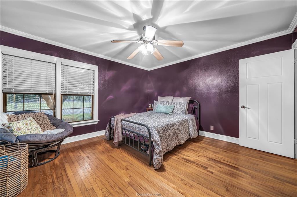 1414 East 29th Street Bryan, TX 77802 - Photo 17 of 21 a bedroom with a bed and wooden floor