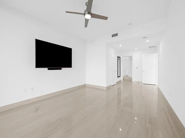 a view of a livingroom with wooden floor and flat screen tv
