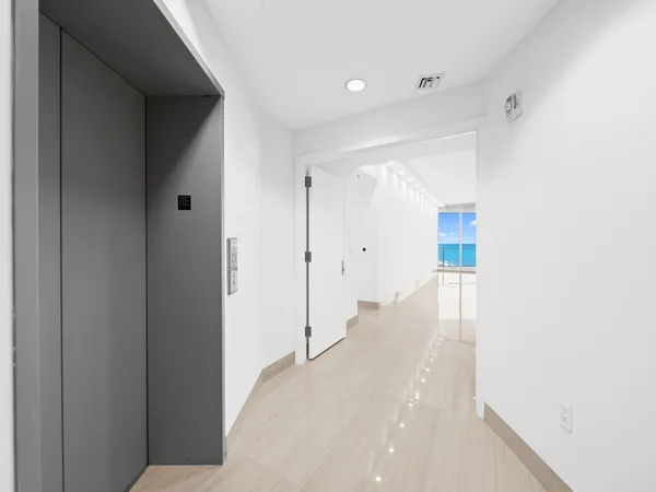 a view of a hallway with wooden shelves
