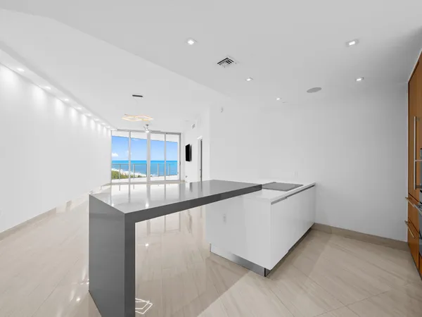 a kitchen with stainless steel appliances granite countertop a sink and a stove