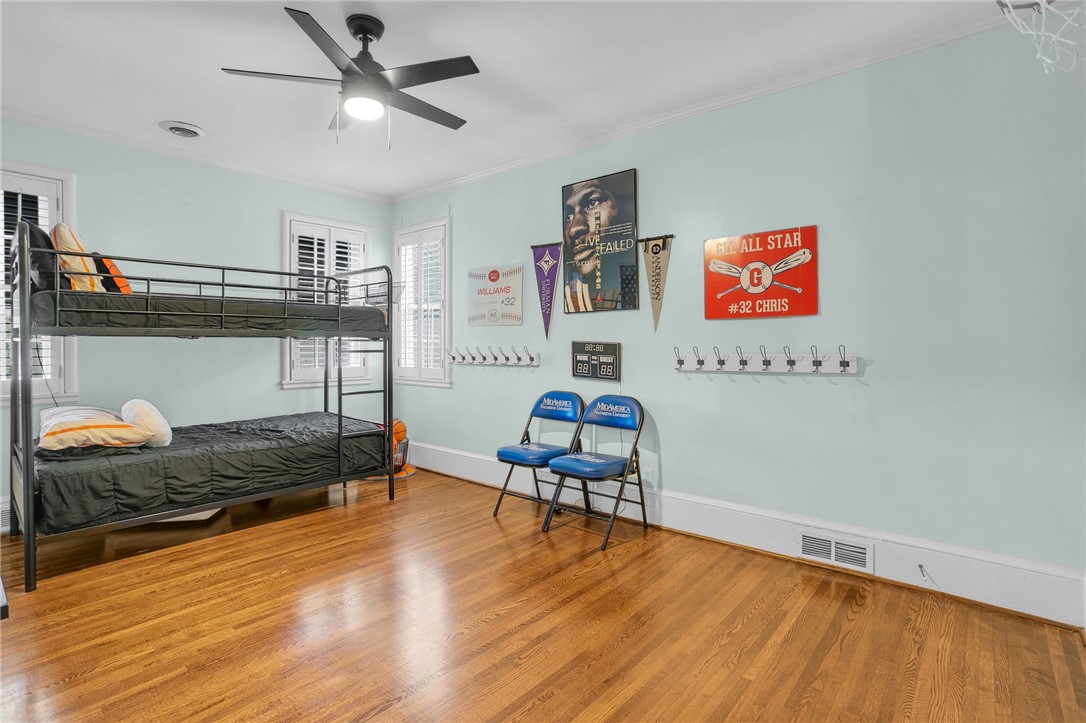 1107 Springdale Road Anderson, SC 29621 - Photo 20 of 49 This spacious bedroom features lustrous hardwood flooring, ample natural light, and a ceiling fan for comfort.