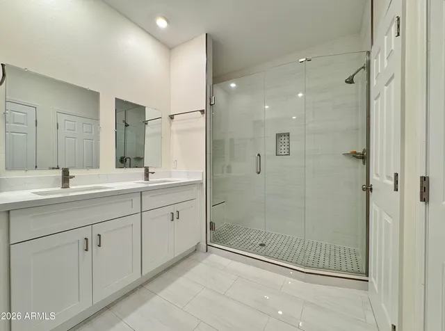 a spacious bathroom with a shower sink vanity and mirror