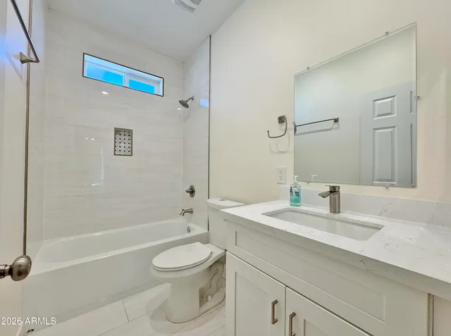 a bathroom with a sink a toilet and a bathtub