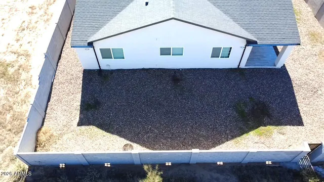 an aerial view of a house with a yard