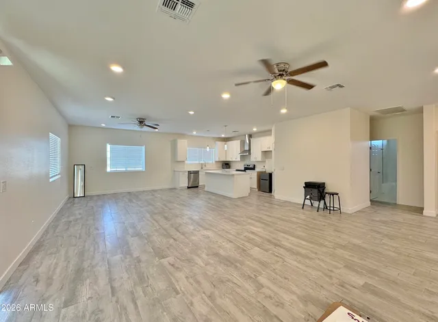 a view of a livingroom with a kitchen counter top and stairs