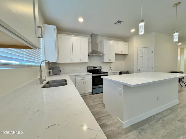a kitchen with a sink stove and cabinets