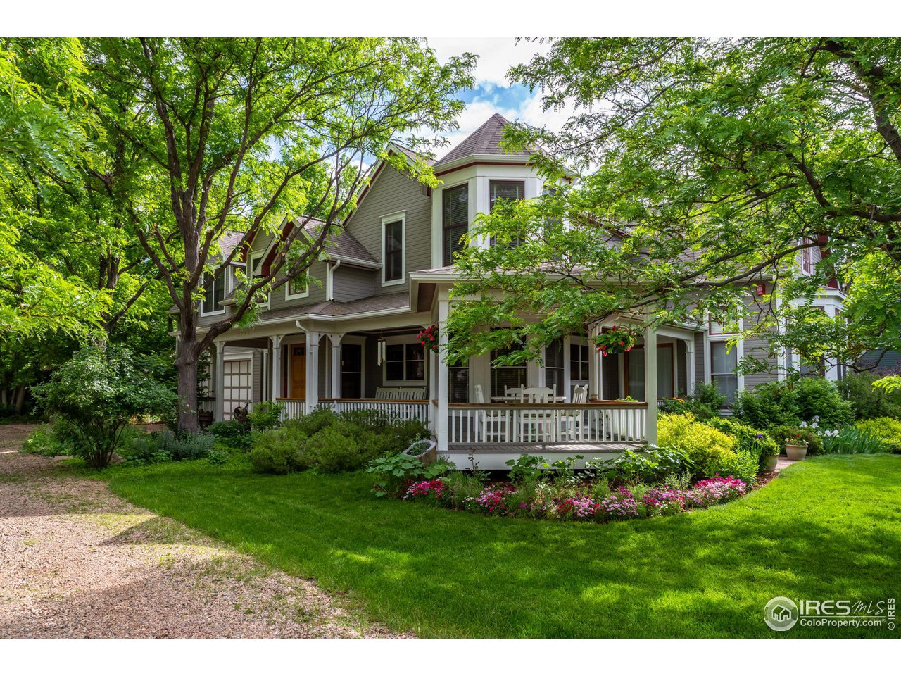 a front view of a house with a yard and potted plants