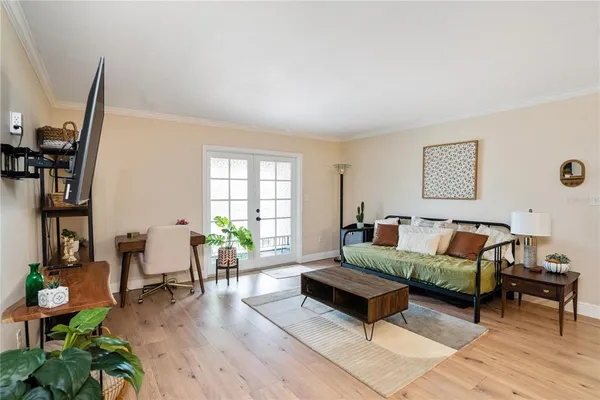 a living room with furniture and wooden floor