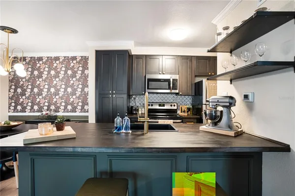 a kitchen with a sink cabinets and appliances
