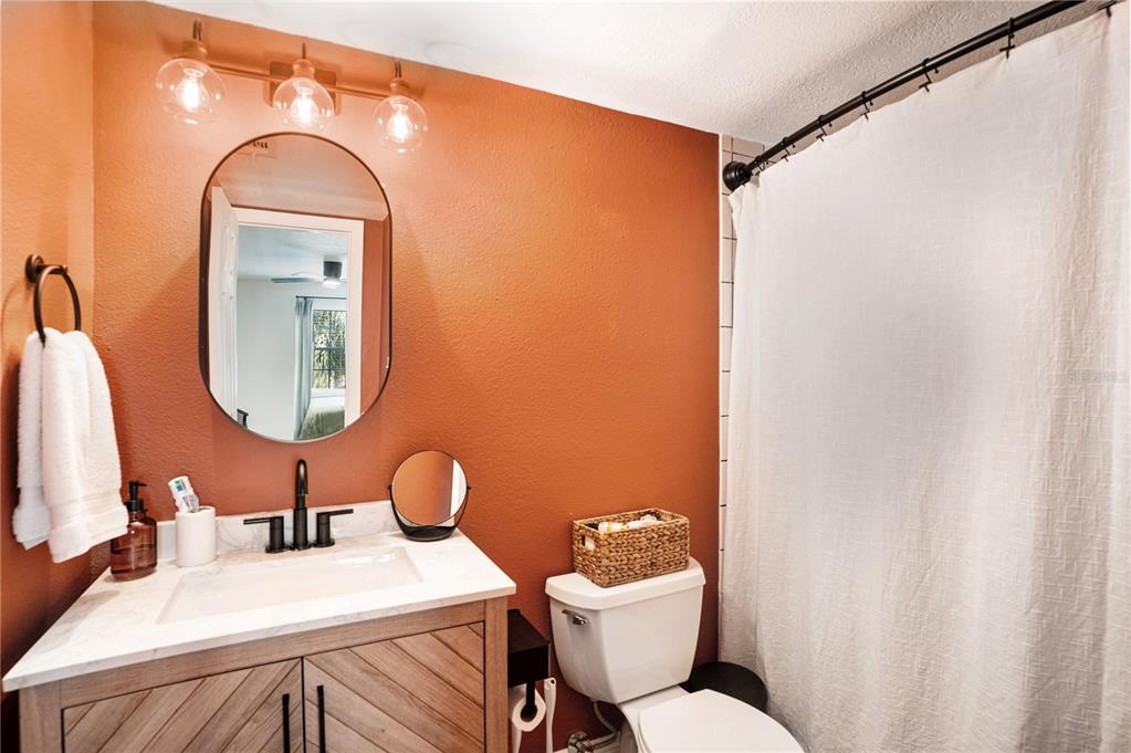5306 Santa Rosa Court, Unit 341 Tampa, FL 33609 - Photo 10 of 20 a bathroom with a toilet sink and mirror