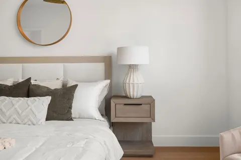 a bed room with a bed and a lamp