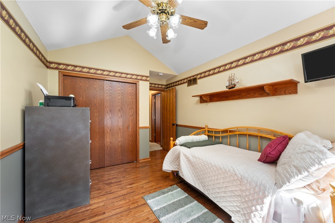 10400 Stoneacre Road Northwest Canal Fulton, OH 44614 - Photo 23 of 44 Bedroom with lofted ceiling, wood finished floors, and a ceiling fan