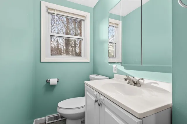 a bathroom with a sink toilet and a mirror