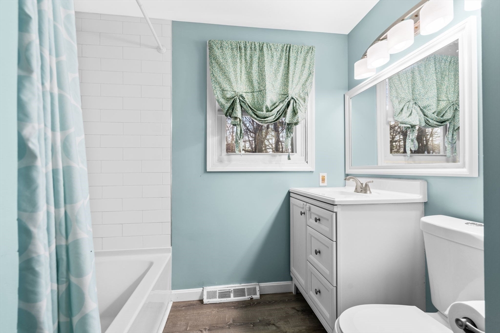 62 Emily Jeffers Road, Unit 62 Randolph, MA 02368 - Photo 13 of 31 a bathroom with a granite countertop sink a toilet and a bathtub