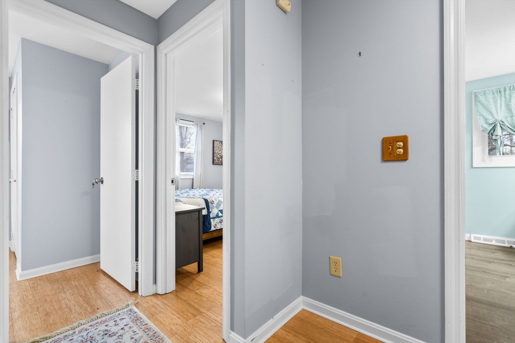 62 Emily Jeffers Road, Unit 62 Randolph, MA 02368 - Photo 15 of 31 a view of a hallway with bathroom and wooden floor