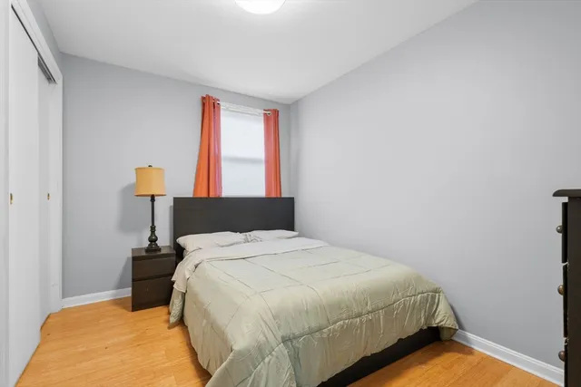 a bedroom with a bed and a lamp