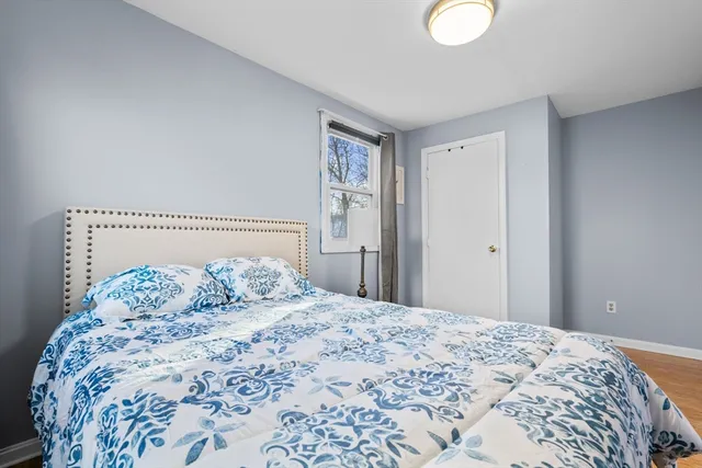 a bedroom with a large bed and a chandelier