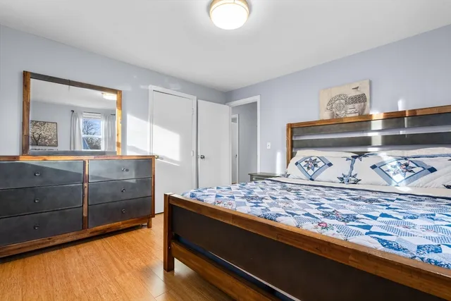 a bedroom with a bed and a dresser